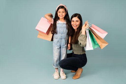 Portrait of a latin family buying a lot of stuff in the mall and feeling excited